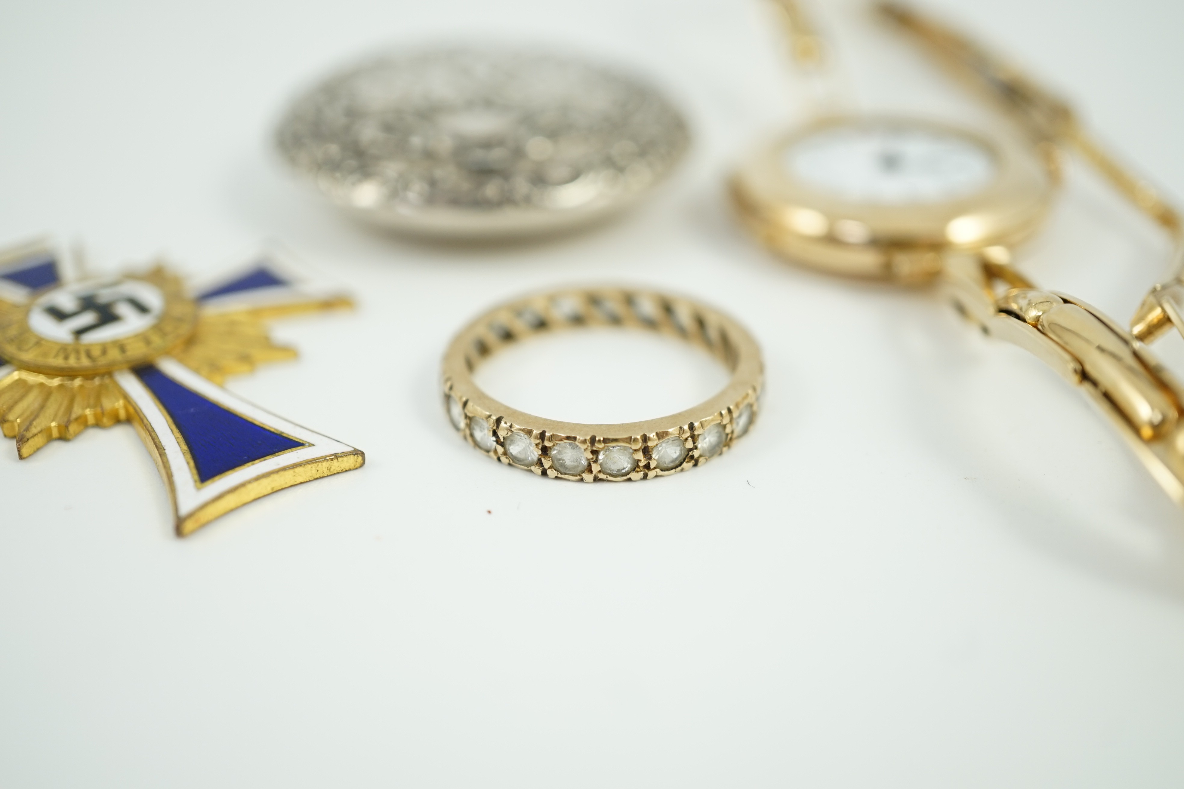 An early 20th century 9ct gold manual wind wrist watch, on a 15ct expanding bracelet, case diameter 28mm, gross weight 25.3 grams, a yellow metal and simulated diamond set eternity ring, A 1930's German git and enamel cr